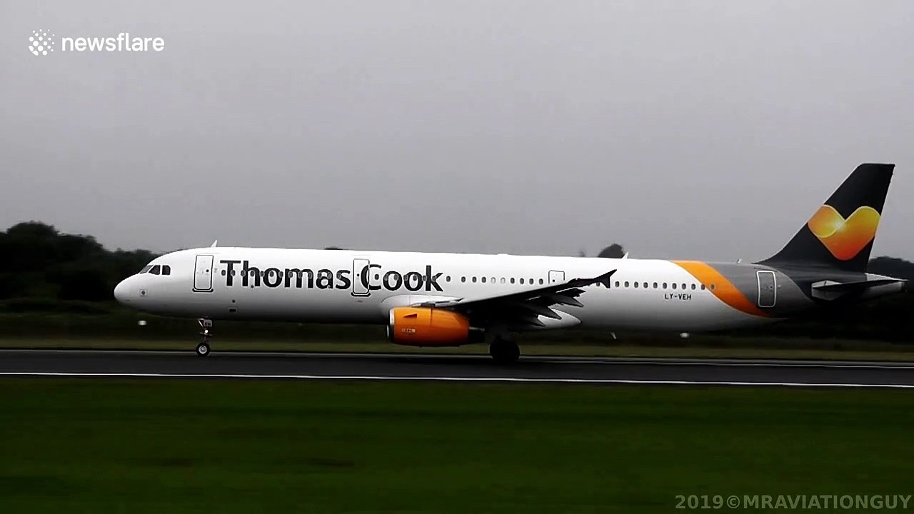 Condensation clouds engulf plane's wings as it takes off from Manchester Airport