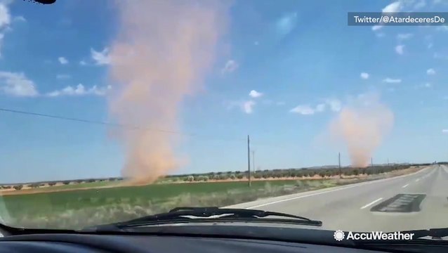 Double dust devils swirl along highway