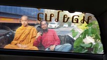 Terrified Buddhist monk looks on nervously as wild ELEPHANT raids pickup truck