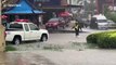 Cars travel through flooded roads in Thai city