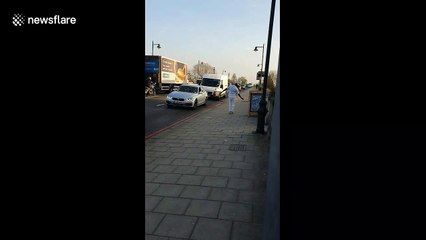 Enthusiastic man performs dance routine across Kew Bridge in London