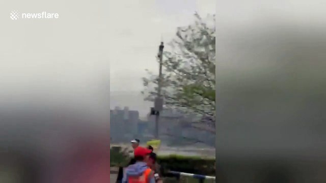 Chopper flying too low blows bollards into path of marathon runners in China