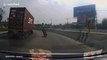 Quick-thinking motorbike rider narrowly avoids being crushed by 40ft long shipping container