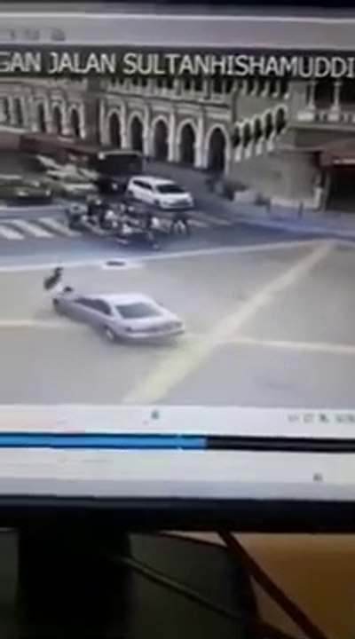 Shocking moment a car rams into a traffic cop in KL