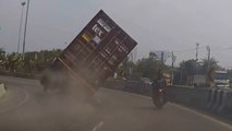 Motorbike rider narrowly escapes being crushed by shipping container in Thailand