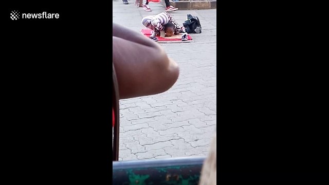 Young girl on street in Kenya shows off mind-bending contortion skills