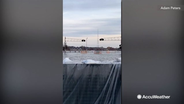 Barrier keeps river floodwaters from spilling into town