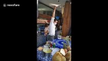 Kung fu master shows off Tai Chi moves while spinning roti pirata dough