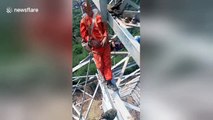 Chinese electrical workers nap on 50-metre-high transmission tower