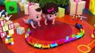 Two cute babies are playing with a toy train which helps them to know ABC and names of animals