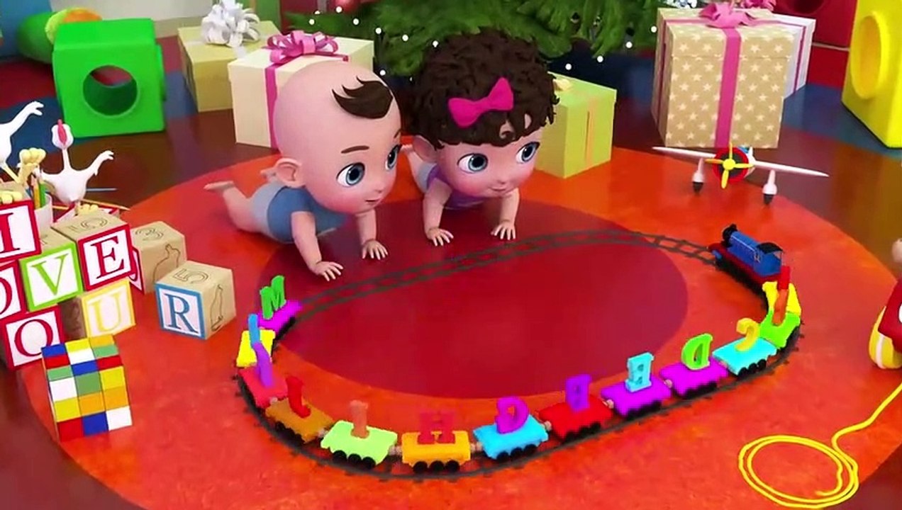 Two cute babies are playing with a toy train which helps them to know ABC and names of animals