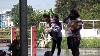 Monkeys cool off in lake as temperatures soar at the start of Thailand's new year