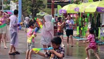 Elephants soak crowds with their trunks in mass water fight