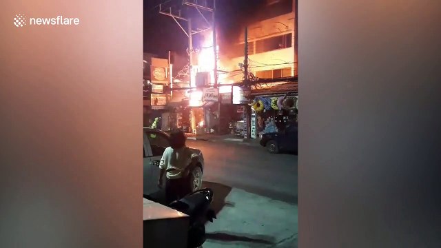 Fire rips through buildings as thousands of tourists splash water in Thai new year celebrations