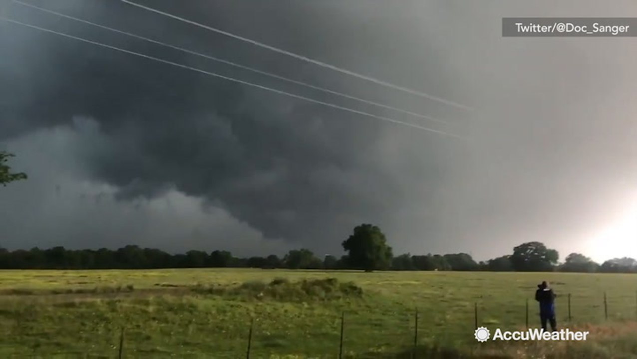 Eerie funnel clouds appear overhead in wake of...