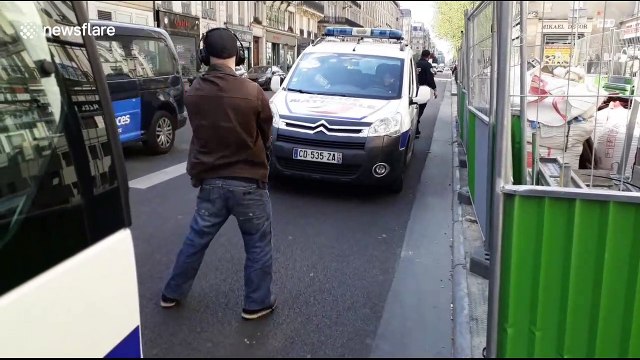 Man performs bizarre dance for police during yellow vest protest in Paris