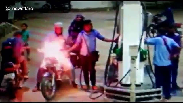 Horrifying moment motorbike catches fire at petrol pump in west India