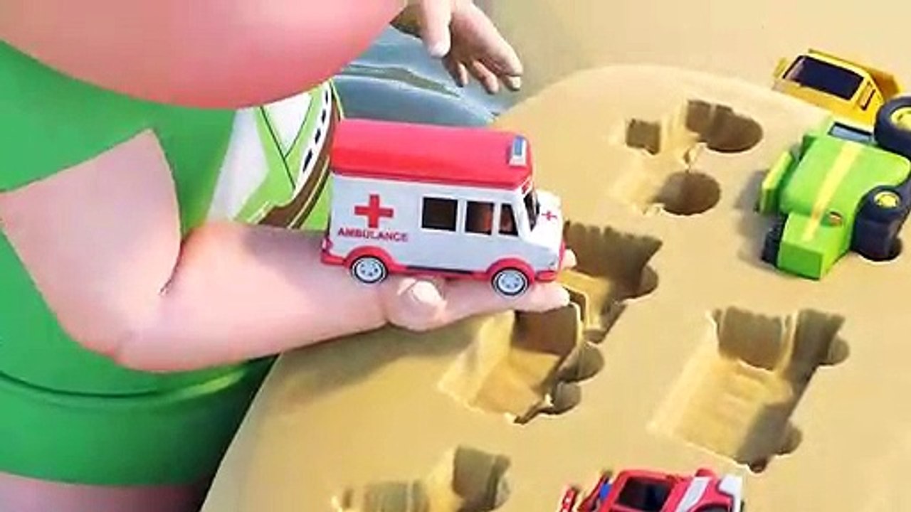 Playing with toy cars in the sea. Games of sand on the beach