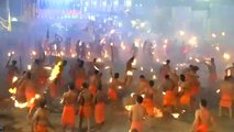 Hindu devotees throw flaming torches during Indian fire festival