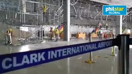 Workers repair Clark International Airport damage caused by strong quake