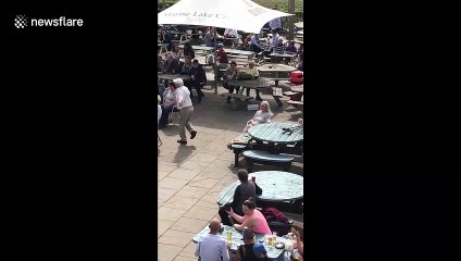 Having the time of his life! Elderly man dances in front of crowd in beer garden
