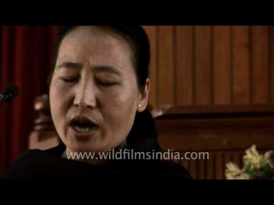 Naga woman leads prayer in a church, Kohima