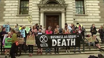 Wailing climate protester outside the Treasury