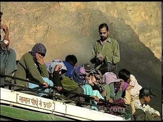 People and bus conductor on top of a bus in Spiti!