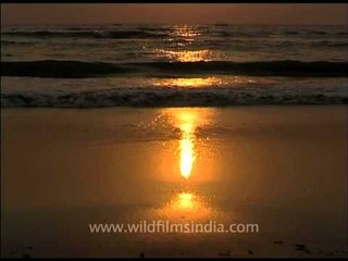 Sunset reflecting on a beach in Goa