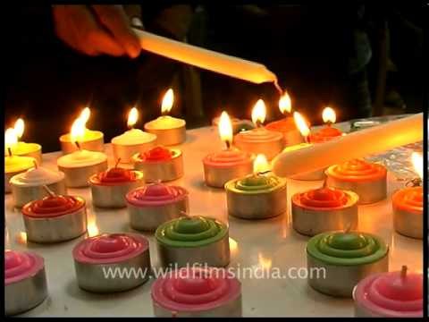 Buddhist monks and devotees praying and lighting candles