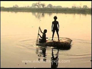Rag picker children scour the Yamuna riverbed for booty