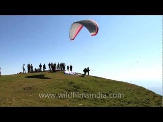 Man parasailing under blue sky