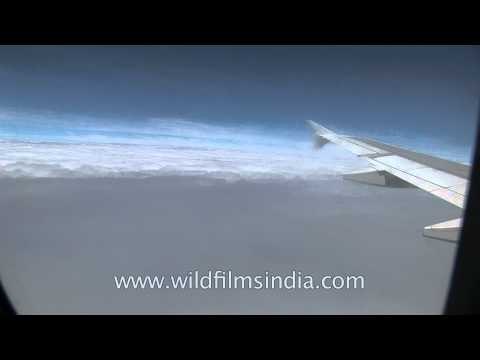 View from airplane window over the clouds