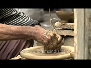 Diya making on a potter's wheel at Paharganj, Delhi