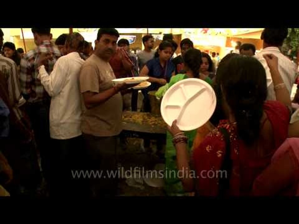 Devotees standing in a queue and waiting for their turn for prashad at Durga Puja