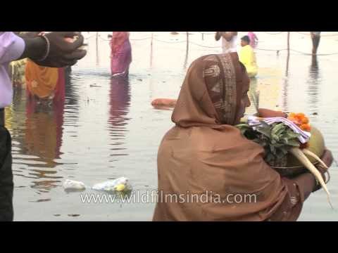 Offering fruits & hymnals to the god of sun on Chhath Puja