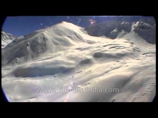 Helicopter on the look out for perfect ski spot in the Himalayas