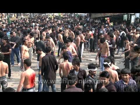Shia Muslims flagellate themselves during Muharram procession