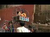 Cute children celebrate Eid festival with small ferris wheel rides