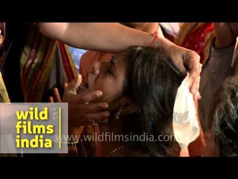 Sticking fingers down patient's throat to make her swallow live fish!