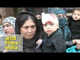 Shia woman carries bleeding child after he is cut in the head on Ashoura