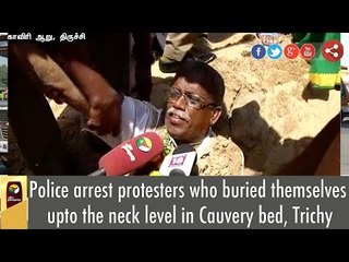 Police pull protesters out of the pit, where they buried themselves as a mark of protest