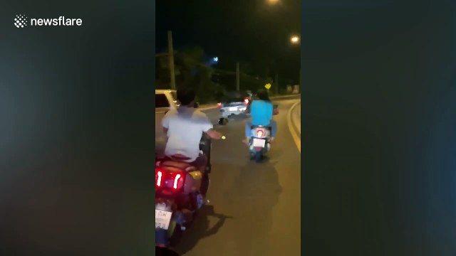 Elderly Thai man clings to pal's car bonnet after they had an argument