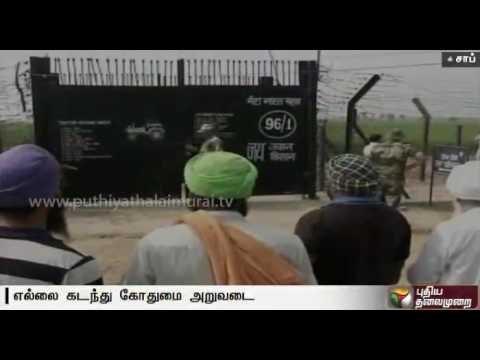 Punjab farmers harvest paddy across border fence near Attari