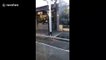 Melbourne man in full cycle gear surprises commuters on Penny-farthing