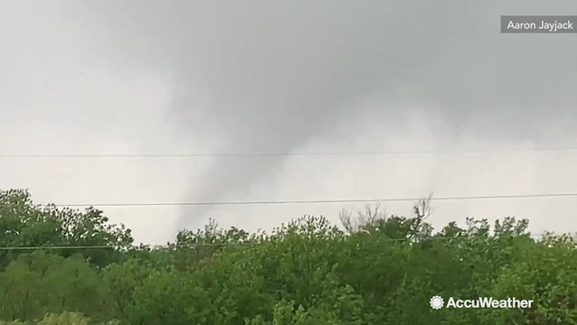 Tornado crosses road as debris goes flying