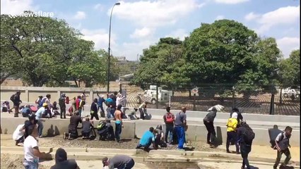 Venezuelan riot police deploy water cannon against rock-throwing protesters in Caracas