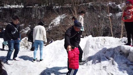 Delighted children play in the snow on Mount Fuji in Japan