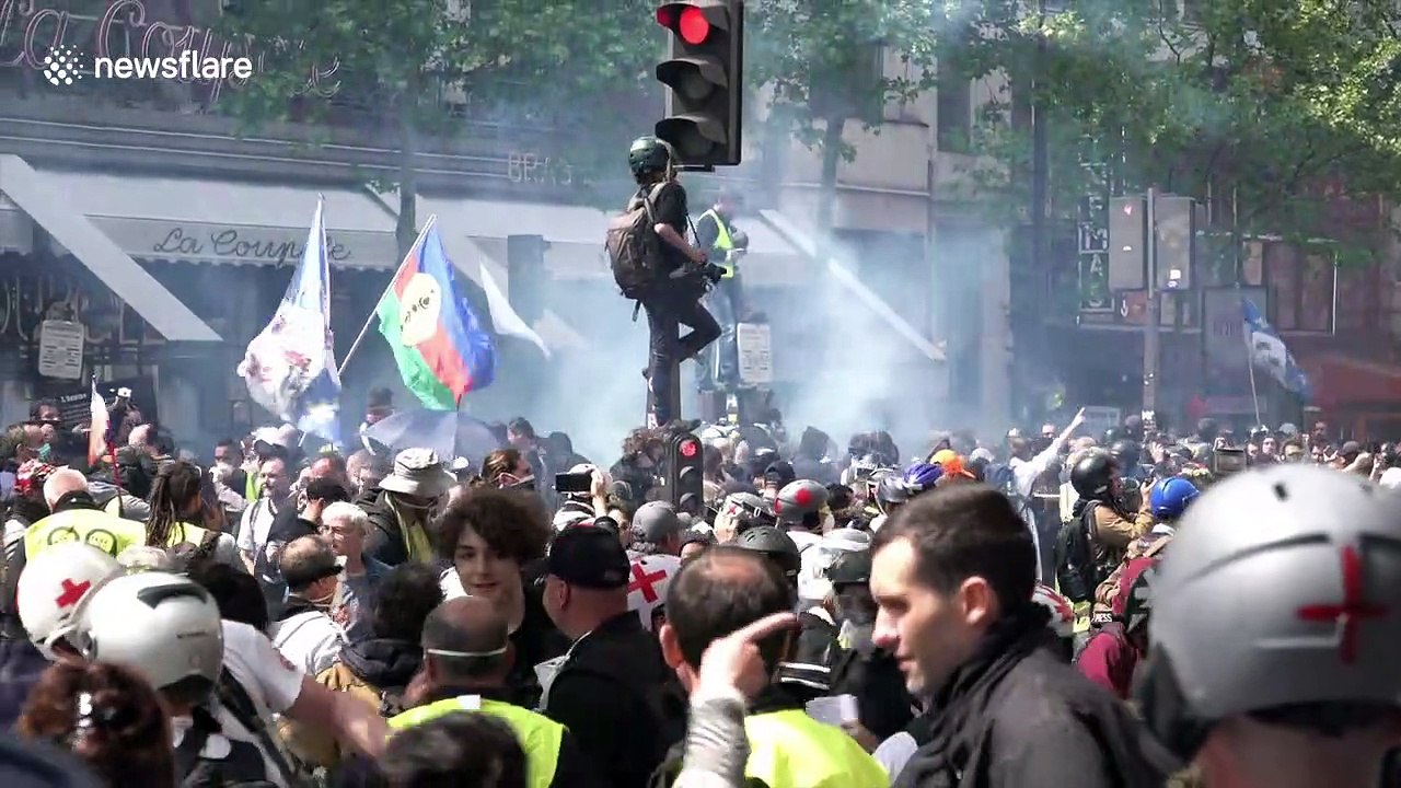 Riot police clash with yellow vest and anti-capitalist 'black bloc' protestors during May Day demonstrations in Paris