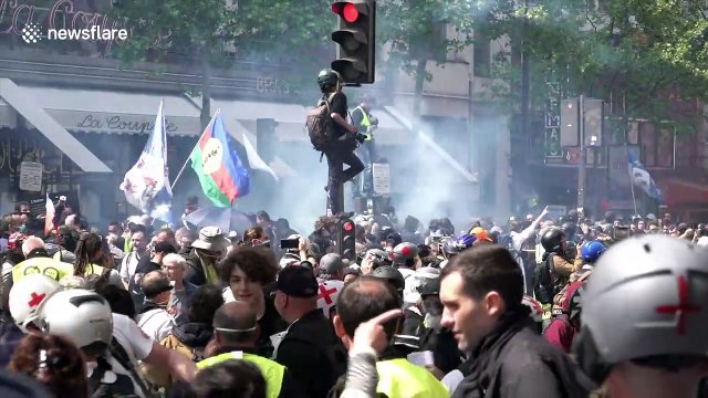 Riot police clash with yellow vest and anti-capitalist 'black bloc' protestors during May Day demonstrations in Paris
